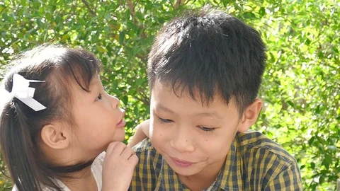 Little sister whisper a story to her bro... | Stock Video | Pond5