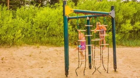 Little sisters playing on playground Stock Footage