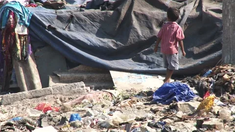 LITTLE SLUM KID IN GARBAGE  Stock Footage 134328253