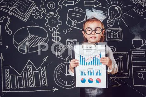 The little smart girl in glasses shows graphics company's activity on dark Stock Photos