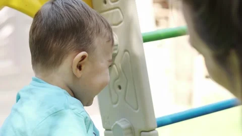 Little smiling boy playing with his mom on the playground Vídeo Stock 248345536