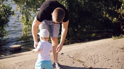 The little son is trying to get to the river. Stock Footage 77525601