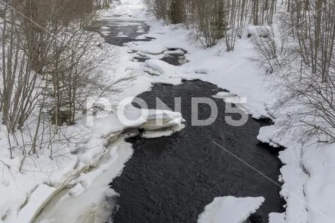 Little stream where the thaw has begun Stock Photos