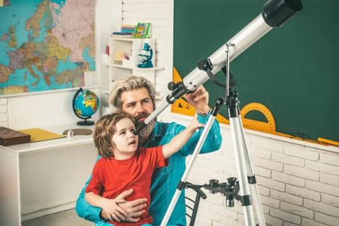 Little student boy happy with an excellent mark. Pupil studies astronomy with Stock Photos