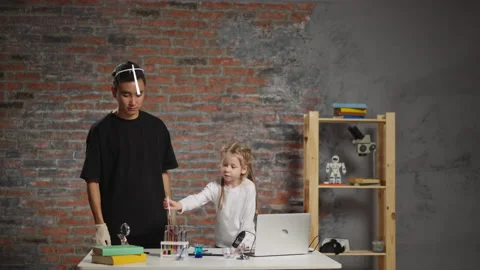 Little student does test with liquids under tutor control Stock Footage 168485675