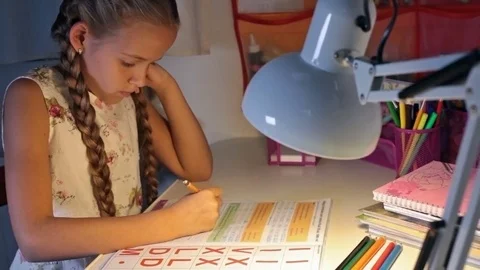 Little student doing homework in the evening Stock Footage 72152257