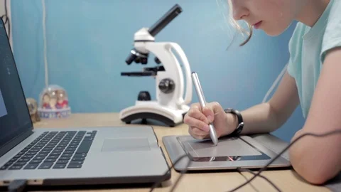 Little student girl learning using laptop and microscope. Video stock 90911214