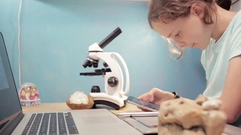 Little student girl learning using laptop and microscope. Stock Footage 90914452