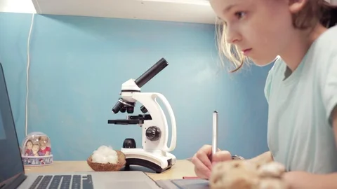 Little student girl learning using laptop and microscope. Stock Footage 90919305