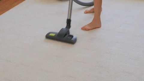 A little sweet girl vacuums and dances. A cute girl is cleaning the house. Stock Footage