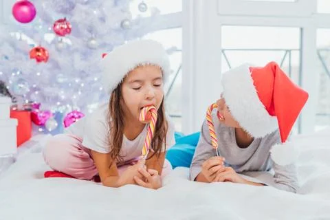 Little sweettooth siblings tasting delicious candies, enjoying the moment Stock Photos