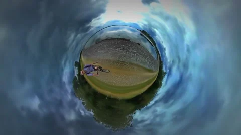 Little Tiny Planet 360 Degree Man Filming Riding a Bicycle Along River Sea Stock Footage 67856911