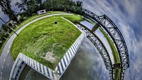 Little Tiny Planet 360 Degree Edge of City Railroad Bridge Over Smooth River Video stock 72003481