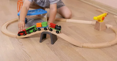 The little toddler boy using imagination to assemble toy train Stock Footage 96213535