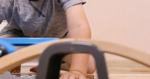 The little toddler boy using imagination to assemble toy train Stock Footage 96213631