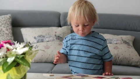 Little toddler doing puzzle. Boy learning basic developing cognitive skills,  Stock Footage 111145786