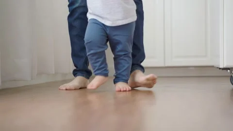 Little toddler having fun learning to walk, Mother support Stock Footage 168220715