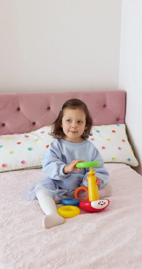 Little toddler kid develops playing with colorful pyramid Video stock 308639125