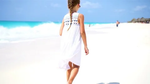Little tourist girl walking at beach during caribbean vacation Stock Footage