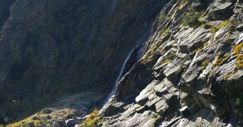 Little waterfall, Handheld view of a small mountain waterfall, on a sunny oct Stock Footage 83836194