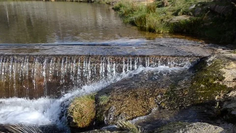 Little waterfall on a river, pan to left. Stock Footage 126938398