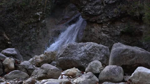 Little waterfall with rocks in foreground Stock Footage 222931944