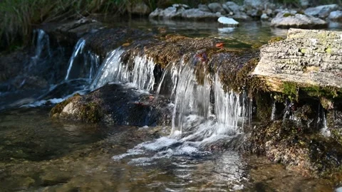 A little waterfall from a small brook in the evening sun Video stock 260846511