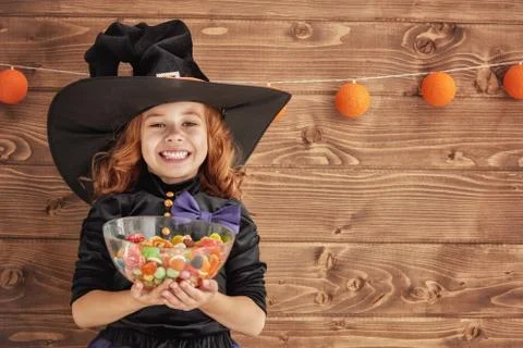 Little witch with candy. Stock Photos