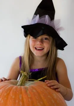 Little witch with pumpkin Stock Photos