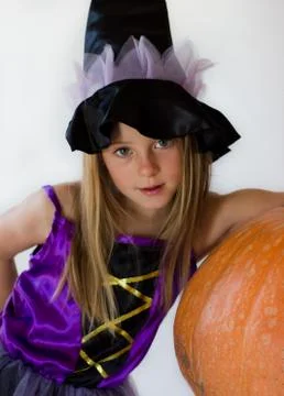 Little witch with pumpkin Stock Photos