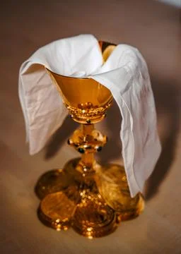A liturgical wine chalice with lavabo cloth Stock Photos