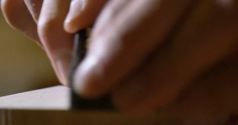 a liutist while building one of his works. violin Stock Footage
