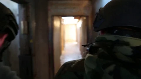 Live Action Shot of Students with Weapons Clearing a Building Stock Footage 70561977