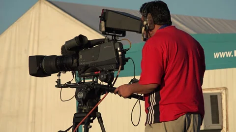 Live broadcast camera operator working outdoors Stock Footage 39301684