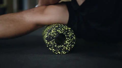 Live camera. Close-up. An unrecognizable man does hamstring rolling with a 스톡 동영상 263409935