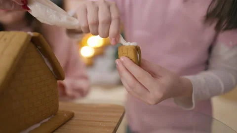 Live camera follows ginger cookie in child hands applying sugar glue putting Video stock 165289792