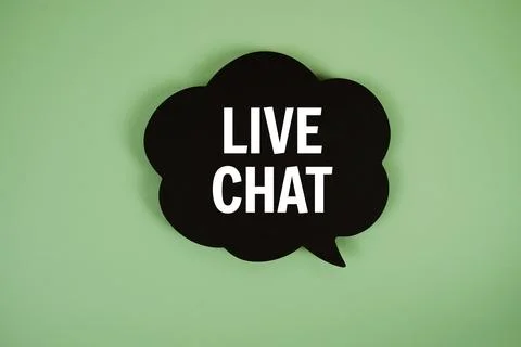 Live Chat text with speech bubble top view on green background Stock Photos