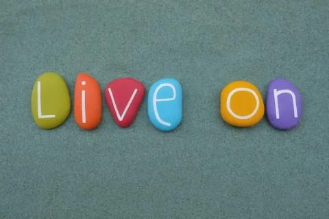 Live on, creative message and logo composed with multilcolored stone letters Stock Photos