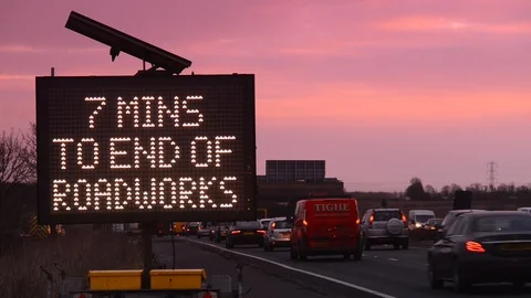 Live digital sign with traffic updates of roadworks at sunrise uk Stock Footage 87973264