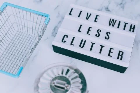 Live with less clutter message on lightbox with shopping basket and trash bin Stock Photos