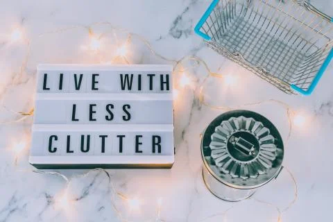 Live with less clutter message on lightbox with shopping basket and trash bin Stock Photos