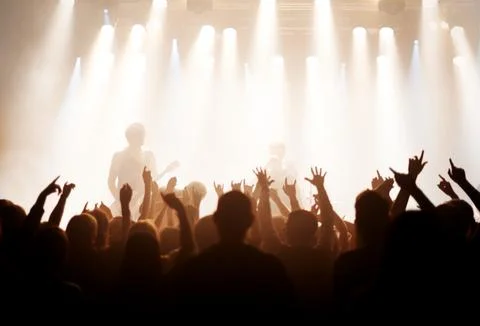 Live music is the only music. Shot of fans enjoying a rock show. Stock Photos