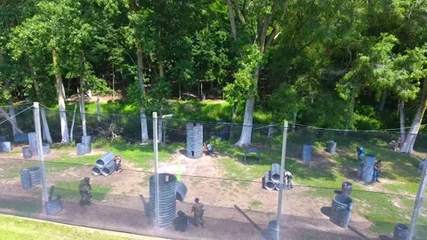 Live paintball action caught on 4k drone flying low Stock Footage 195881454
