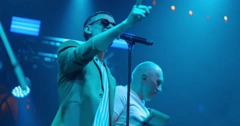 Live performance singer man on glasses, dancing on concert musician stage with Stock Footage 197006000