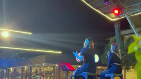 Live Performance by Two Singers at a Night Market Stage Stock Footage 295793790