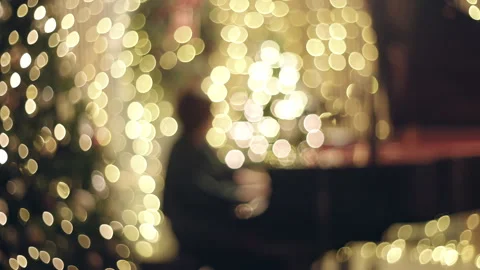 Live Piano Player Playing In front of Christmas Holiday Tree and Lights Bokeh Stock Footage 321376973
