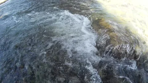 Live stone glowing on water with bubbles shining on the sun Stock Footage 146259334