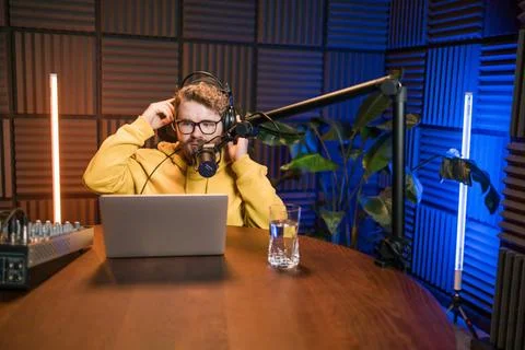 Live streaming with smiling millennial man as radio presenter with microph... Stock Photos
