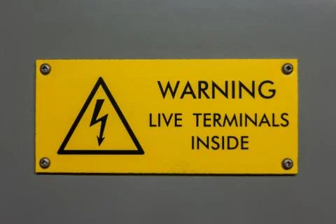 Live terminals inside warning sign Stock Photos