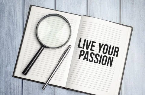 LIVE YOUR PASSION text on diary and magnifier Stock Photos